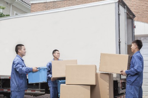 Movers carrying furniture in a Kentish Town flat with stairs