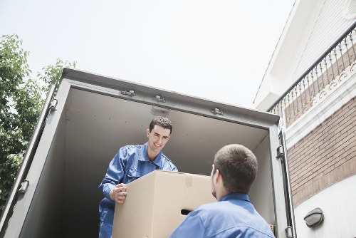 Furniture and boxes ready for transport by man with van